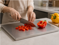 Cutting bell peppers on stainless steel chopping board